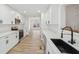 Modern kitchen with white cabinets, stainless appliances, quartz countertops and wood-look floors at 4554 Alaspair Ln, Acworth, GA 30101