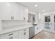 Kitchen featuring white cabinets, quartz countertops, stainless appliances and sliding door to backyard at 4554 Alaspair Ln, Acworth, GA 30101