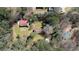 An aerial view of a property with a house, barn, and lush surroundings in a wooded area at 5190 Paul Sw Cir, Conyers, GA 30094