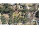 An aerial view shows a house with barn, surrounded by lush trees on a large lot at 5190 Paul Sw Cir, Conyers, GA 30094