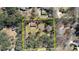 Aerial view of large property with a house and barn surrounded by a wooded area at 5190 Paul Sw Cir, Conyers, GA 30094