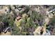 An aerial view of property with house, barn, and neighborhood surrounded by lush trees at 5190 Paul Sw Cir, Conyers, GA 30094