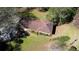 An aerial view shows the roof of a house surrounded by trees, atop a green lawn at 5190 Paul Sw Cir, Conyers, GA 30094
