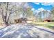 Expansive backyard featuring mature trees, open space, and a charming red barn for versatile use at 5190 Paul Sw Cir, Conyers, GA 30094