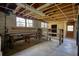 Unfinished basement space featuring exposed ceiling beams, concrete floors, workbench, and natural light at 5190 Paul Sw Cir, Conyers, GA 30094