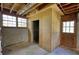 Unfinished basement featuring concrete walls, a door to the outside, and a plywood storage area at 5190 Paul Sw Cir, Conyers, GA 30094