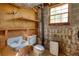 A basement bathroom with a sink, toilet, and a small window providing natural light at 5190 Paul Sw Cir, Conyers, GA 30094