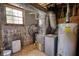 Basement utility room featuring a hot water tank, HVAC unit, and small window at 5190 Paul Sw Cir, Conyers, GA 30094
