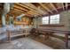 Unfinished basement with concrete walls, exposed ceiling, workbench, and visible electrical panel at 5190 Paul Sw Cir, Conyers, GA 30094