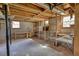 An unfinished basement with exposed wooden beams, cinder block walls and built-in shelves at 5190 Paul Sw Cir, Conyers, GA 30094