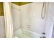 Close-up view of the bathtub, tile surround, shower curtain, and plumbing fixtures in the bathroom at 5190 Paul Sw Cir, Conyers, GA 30094