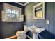 Bathroom with beadboard walls, white fixtures, and window for natural light at 5190 Paul Sw Cir, Conyers, GA 30094
