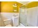 Bathroom with walk-in shower, a single sink vanity, and yellow walls at 5190 Paul Sw Cir, Conyers, GA 30094