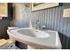 Bathroom featuring a white pedestal sink, classic faucet, and beadboard wall detail at 5190 Paul Sw Cir, Conyers, GA 30094
