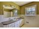 Bathroom features a vanity with a large mirror, ample lighting, and a large window bringing natural light at 5190 Paul Sw Cir, Conyers, GA 30094
