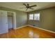 Bedroom with hardwood floors, closet, and natural light from a window at 5190 Paul Sw Cir, Conyers, GA 30094