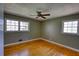 Bedroom featuring hardwood floors, large windows, and a ceiling fan at 5190 Paul Sw Cir, Conyers, GA 30094