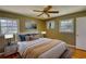 Cozy bedroom featuring a ceiling fan, two windows, bedside tables, and an inviting queen-size bed with stylish throw pillows at 5190 Paul Sw Cir, Conyers, GA 30094