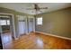 Bedroom featuring wood floors, a nearby bathroom, window, and closets at 5190 Paul Sw Cir, Conyers, GA 30094