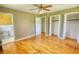 Bedroom features wood floors, a nearby bathroom, and dual closets at 5190 Paul Sw Cir, Conyers, GA 30094