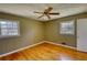 Bedroom with hardwood floors, two large windows, and a ceiling fan at 5190 Paul Sw Cir, Conyers, GA 30094