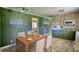 Kitchen dining area with green walls and neutral cabinets and appliances at 5190 Paul Sw Cir, Conyers, GA 30094