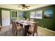Dining Room with green walls, a ceiling fan, and views of nature at 5190 Paul Sw Cir, Conyers, GA 30094