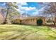 Sprawling ranch-style home with a lush green lawn and mature trees on a sunny day at 5190 Paul Sw Cir, Conyers, GA 30094