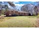 Charming brick home with large front yard and mature trees, perfect for outdoor enjoyment at 5190 Paul Sw Cir, Conyers, GA 30094