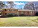 Charming brick home with large front yard and mature trees, perfect for outdoor enjoyment at 5190 Paul Sw Cir, Conyers, GA 30094