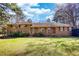 Beautiful single-Gathering brick home with a well-manicured lawn, mature trees, and a welcoming entrance at 5190 Paul Sw Cir, Conyers, GA 30094