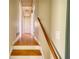 Hallway with wood floors, white walls, staircase with wood handrail, and doorway views to other rooms at 5190 Paul Sw Cir, Conyers, GA 30094