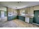 Bright kitchen with two-tone cabinets, modern appliances, and vinyl tile flooring at 5190 Paul Sw Cir, Conyers, GA 30094