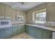 Spacious kitchen features two-tone cabinets, a double sink, and a window at 5190 Paul Sw Cir, Conyers, GA 30094