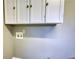 Laundry area features white cabinets, painted walls, and connections for a washing machine at 5190 Paul Sw Cir, Conyers, GA 30094