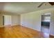 Large living room with hardwood floors and open doorway to kitchen at 5190 Paul Sw Cir, Conyers, GA 30094