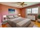 Bedroom featuring a salmon colored wall, large window and a bed with a gray comforter at 5190 Paul Sw Cir, Conyers, GA 30094