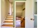 Stairway featuring wood steps, white risers, and view into basement area at 5190 Paul Sw Cir, Conyers, GA 30094