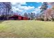 Exterior back yard showing shed, home in the distance, and lush lawn at 5190 Paul Sw Cir, Conyers, GA 30094