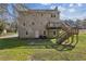 Exterior view of a two-story home with a back deck and a well-maintained lawn at 928 Gate Post Ln, Lawrenceville, GA 30044