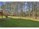 Expansive backyard with lush green grass and views of the surrounding trees and home at 928 Gate Post Ln, Lawrenceville, GA 30044