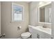 Bathroom features a window, and vanity with sink, toilet and updated fixtures at 928 Gate Post Ln, Lawrenceville, GA 30044