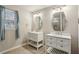 Bathroom features tile floors, natural light, and dual vanities with sinks at 928 Gate Post Ln, Lawrenceville, GA 30044