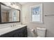 This well-lit bathroom features a stylish vanity, toilet, and modern fixtures at 928 Gate Post Ln, Lawrenceville, GA 30044