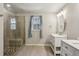 Bright bathroom featuring tile floors, natural light, dual vanities and glass shower at 928 Gate Post Ln, Lawrenceville, GA 30044