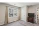 This bedroom features a window with curtains and a television set on the corner at 928 Gate Post Ln, Lawrenceville, GA 30044