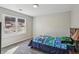 Cozy bedroom features a large window, plush carpeting, and a fun, themed comforter at 928 Gate Post Ln, Lawrenceville, GA 30044