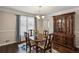 Elegant dining room with hardwood floors, a beautiful light fixture, and ample space for entertaining guests at 928 Gate Post Ln, Lawrenceville, GA 30044