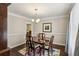 Cozy dining room with a classic table setting, beautiful hardwood floors, and natural lighting at 928 Gate Post Ln, Lawrenceville, GA 30044