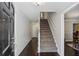 Warm and welcoming foyer with hardwood floors and staircase, leading to the upper level of the home at 928 Gate Post Ln, Lawrenceville, GA 30044